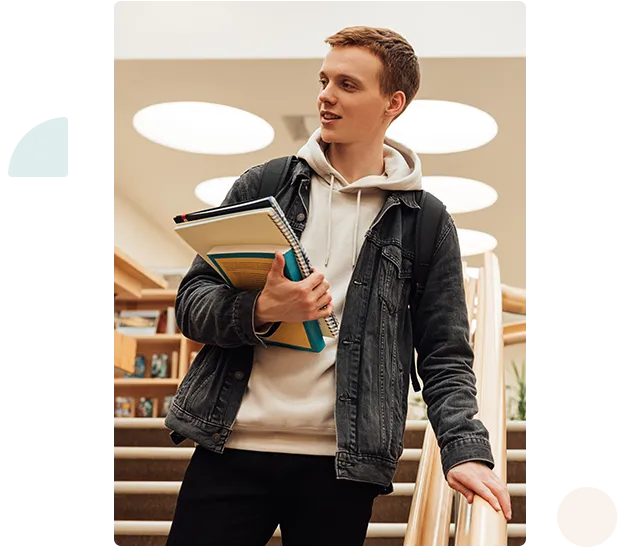 a person holding books and looking away